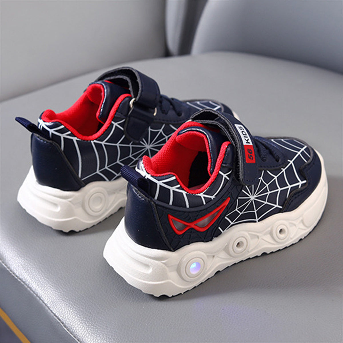 New children's cartoon sports shoes with lights in spring and autumn, leather spider web LED luminous children's shoes for 1-6 years old boys