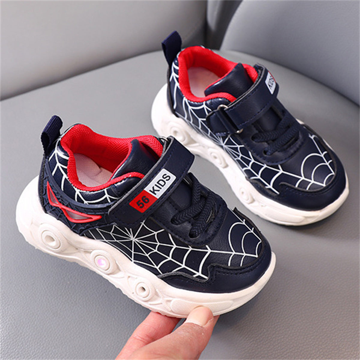 New children's cartoon sports shoes with lights in spring and autumn, leather spider web LED luminous children's shoes for 1-6 years old boys