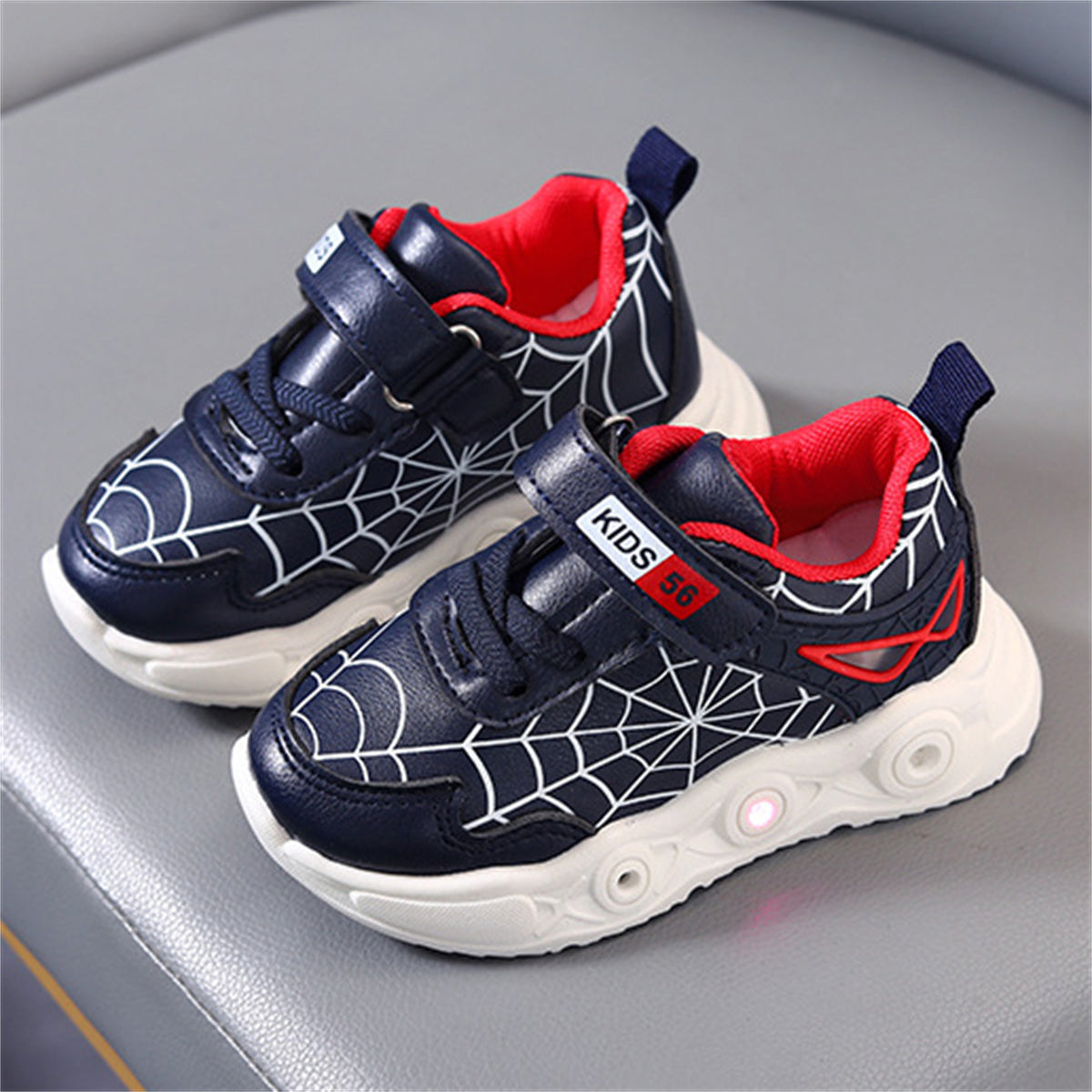 New children's cartoon sports shoes with lights in spring and autumn, leather spider web LED luminous children's shoes for 1-6 years old boys