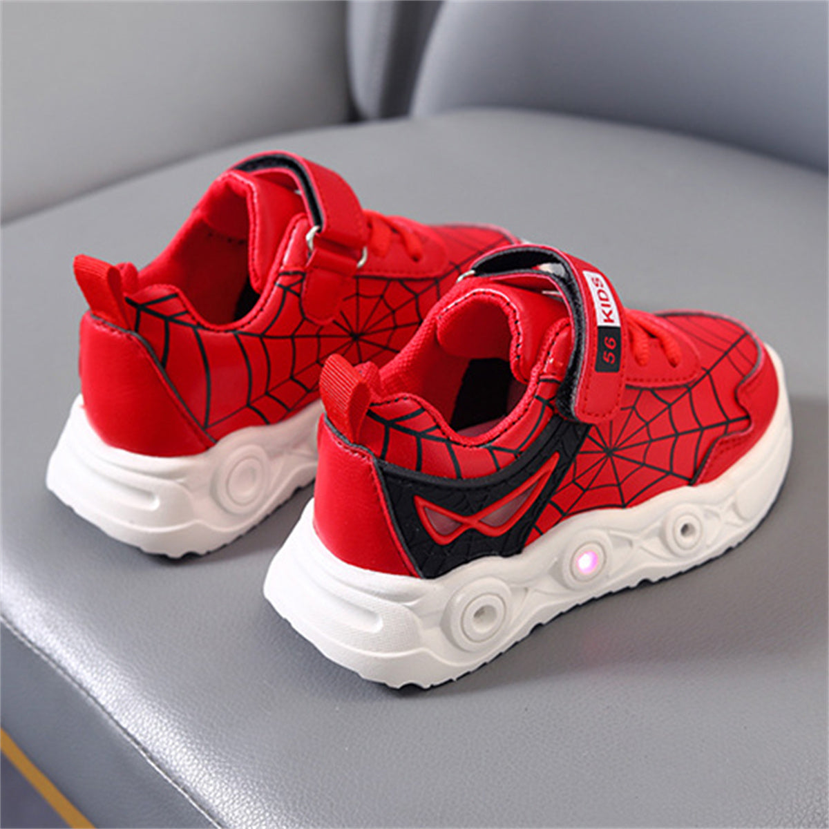 New children's cartoon sports shoes with lights in spring and autumn, leather spider web LED luminous children's shoes for 1-6 years old boys