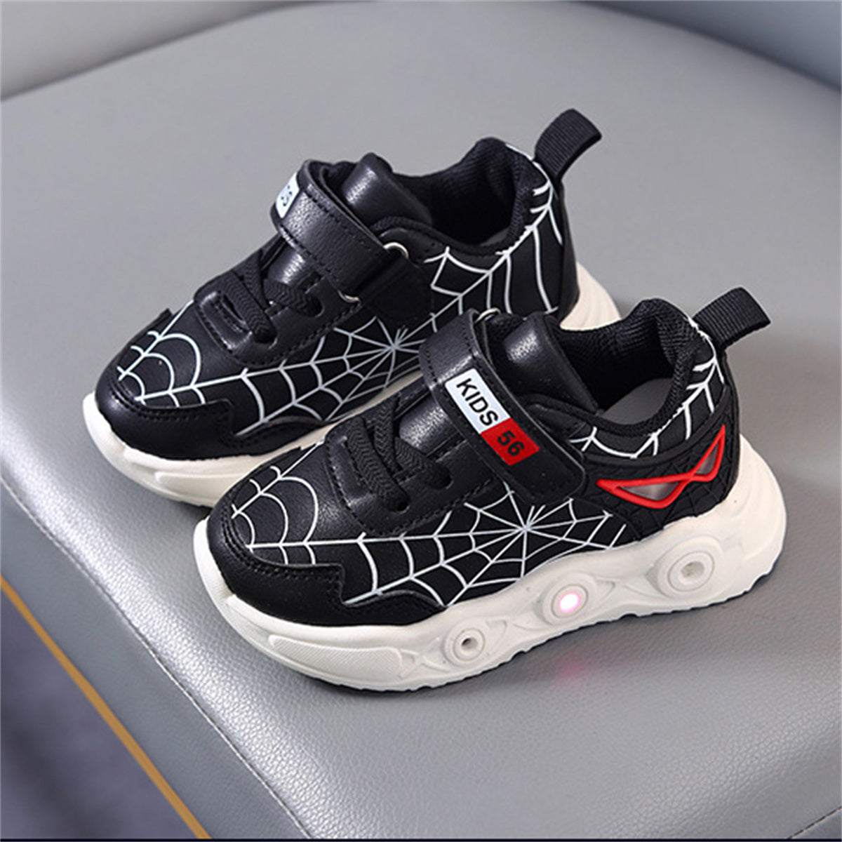 New children's cartoon sports shoes with lights in spring and autumn, leather spider web LED luminous children's shoes for 1-6 years old boys