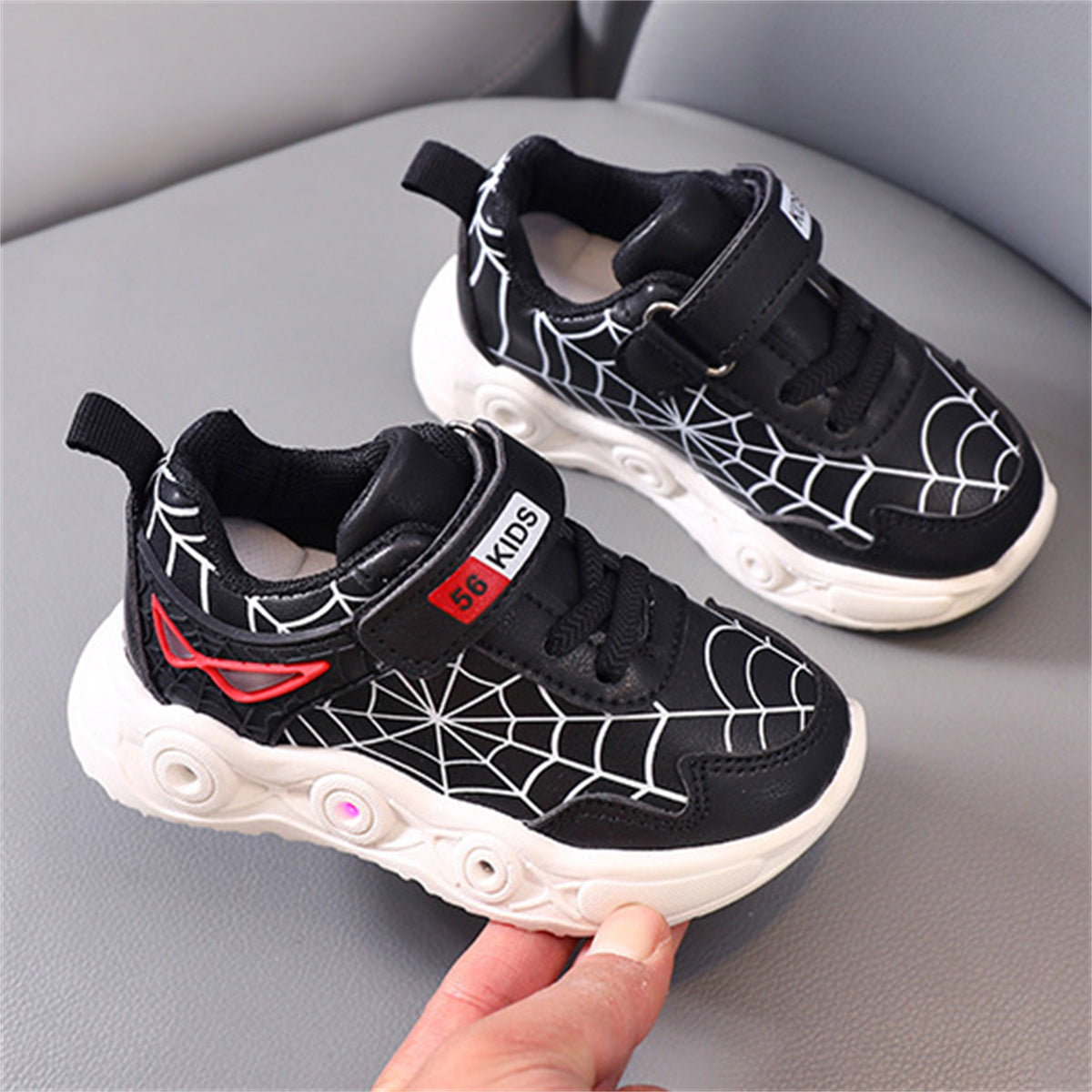 New children's cartoon sports shoes with lights in spring and autumn, leather spider web LED luminous children's shoes for 1-6 years old boys