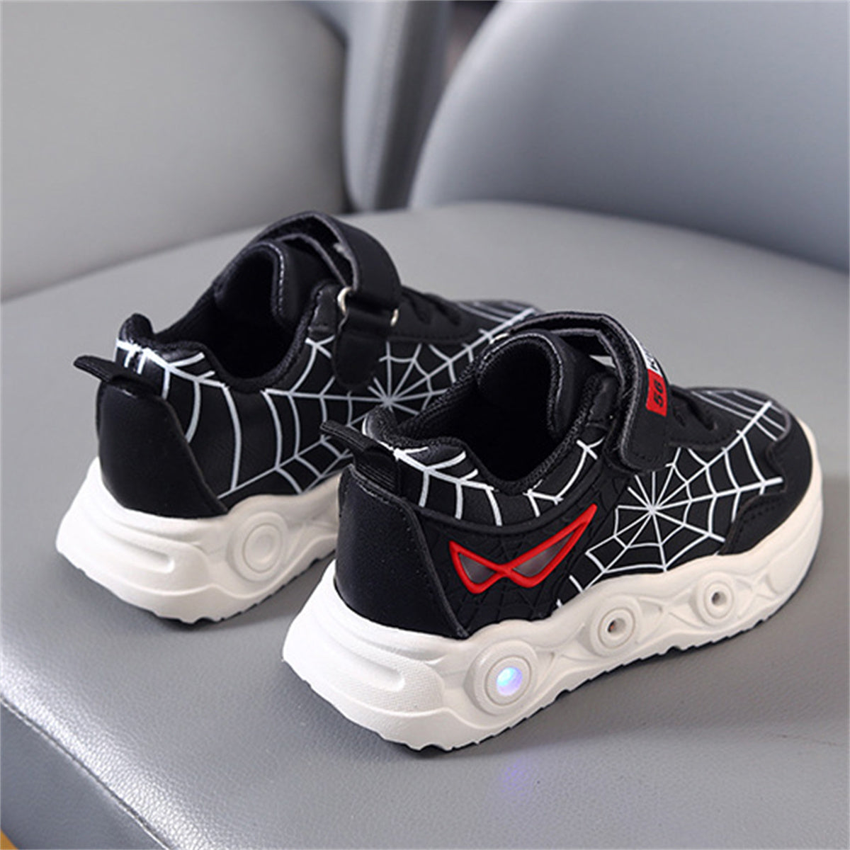 New children's cartoon sports shoes with lights in spring and autumn, leather spider web LED luminous children's shoes for 1-6 years old boys