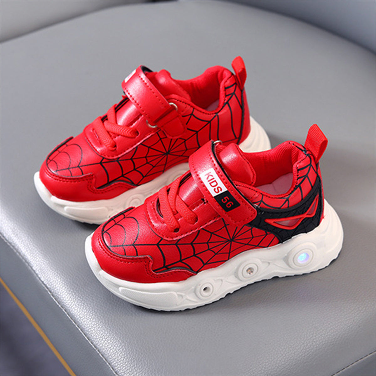 New children's cartoon sports shoes with lights in spring and autumn, leather spider web LED luminous children's shoes for 1-6 years old boys